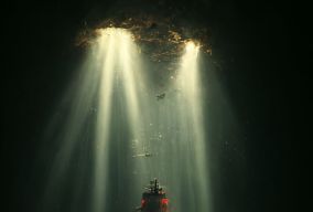 一艘金属战舰漂浮在巨大洞穴内